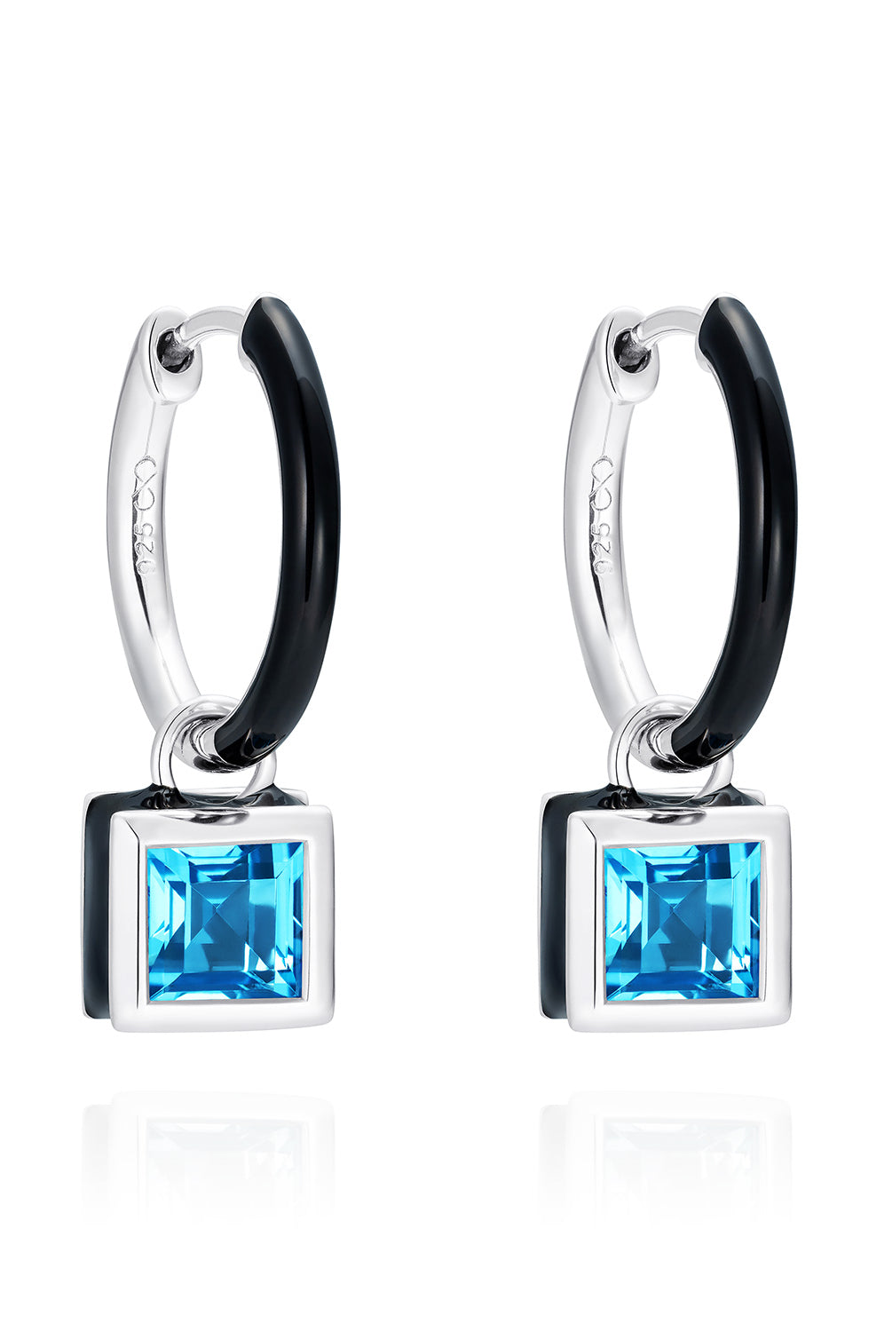 Reversible sterling silver huggie hoop earrings with square blue topaz drops, hand-applied black enamel on one side and striking silver on the other - Something Blue By Ostro