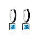 Reversible sterling silver huggie hoop earrings with square blue topaz drops, hand-applied black enamel on one side and striking silver on the other - Something Blue By Ostro