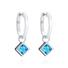 Reversible sterling silver hoop earrings with square blue topaz drops, hand-applied black enamel on one side and white enamel on the other - Something Blue By Ostro